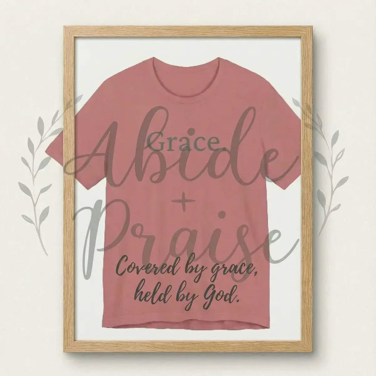 Framed t-shirt with 'Grace. Tee Abide + Praise' text on a white background