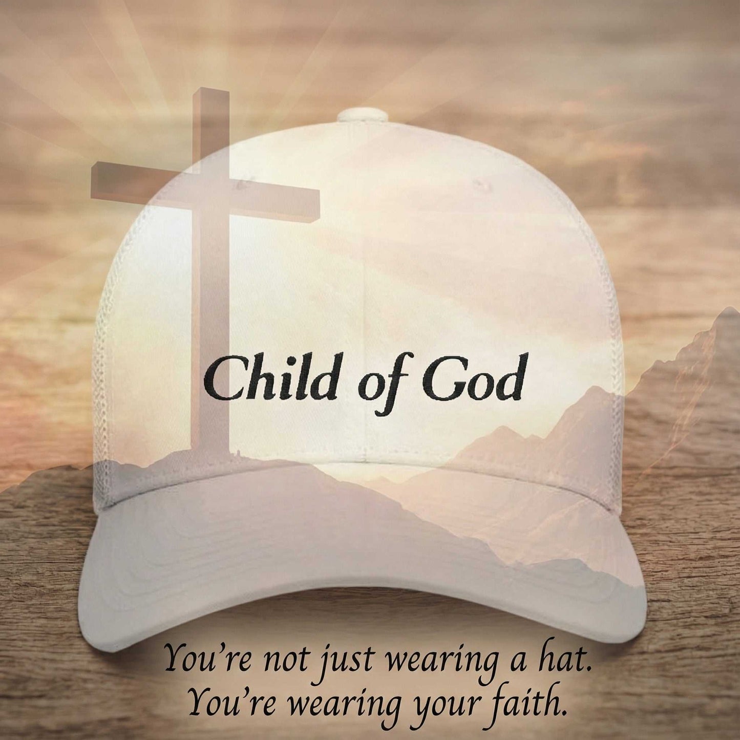 Cap with 'Child of God Trucker Hat' text and cross design on a wooden surface with mountain background