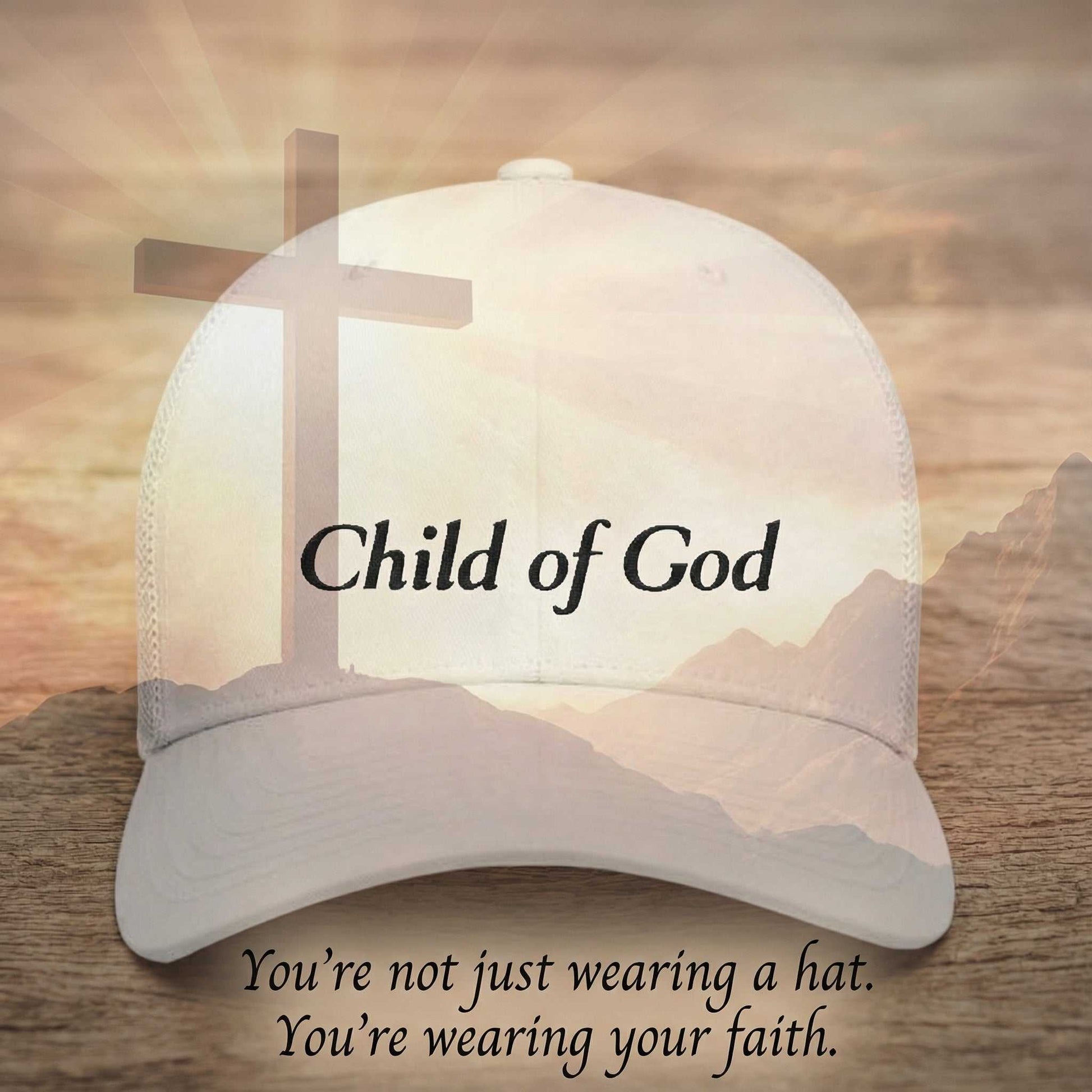 Cap with 'Child of God Trucker Hat' text and cross design on a wooden surface with mountain background