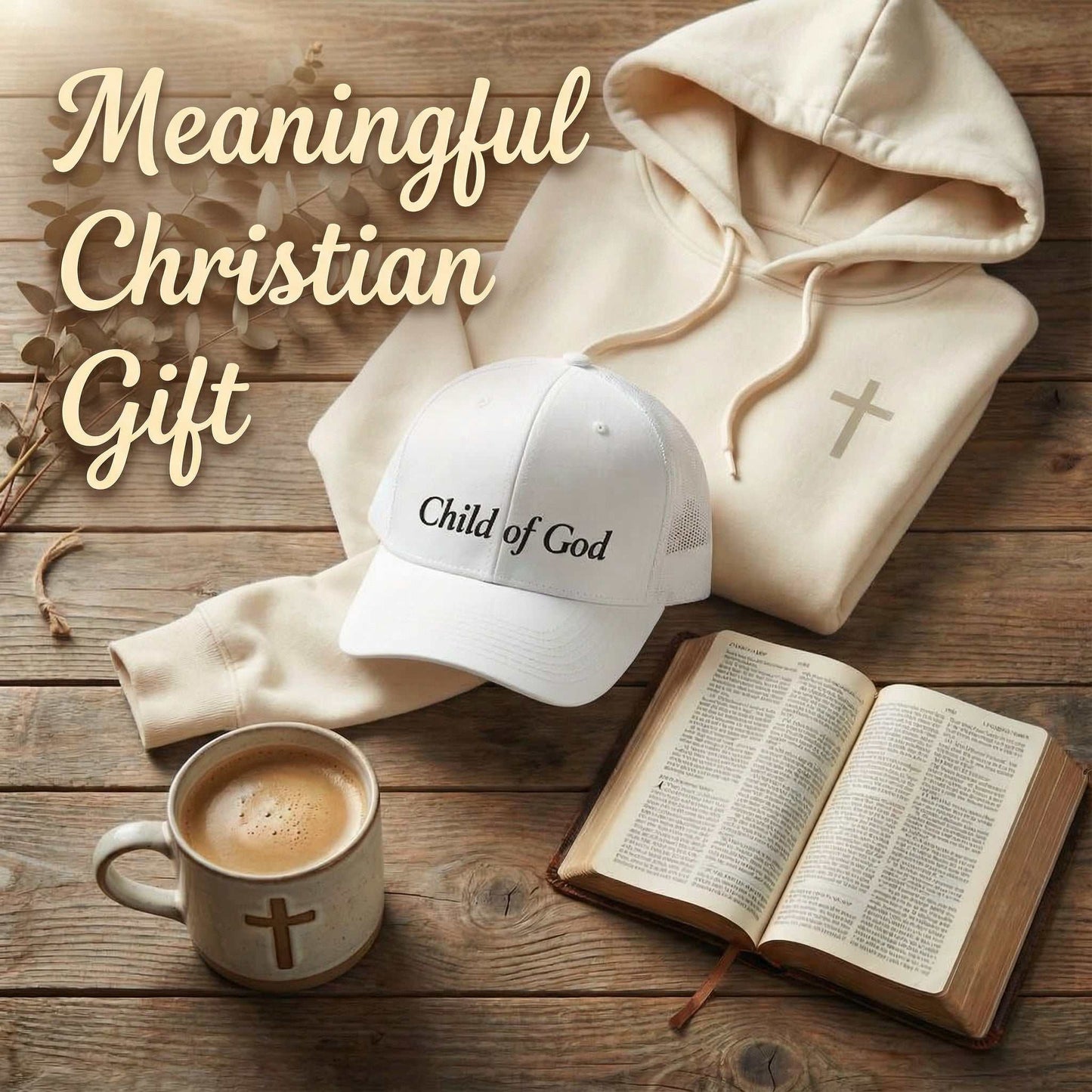 White hoodie, cap, mug with cross, and open book on wooden surface with 'Meaningful Christian Gift' text.